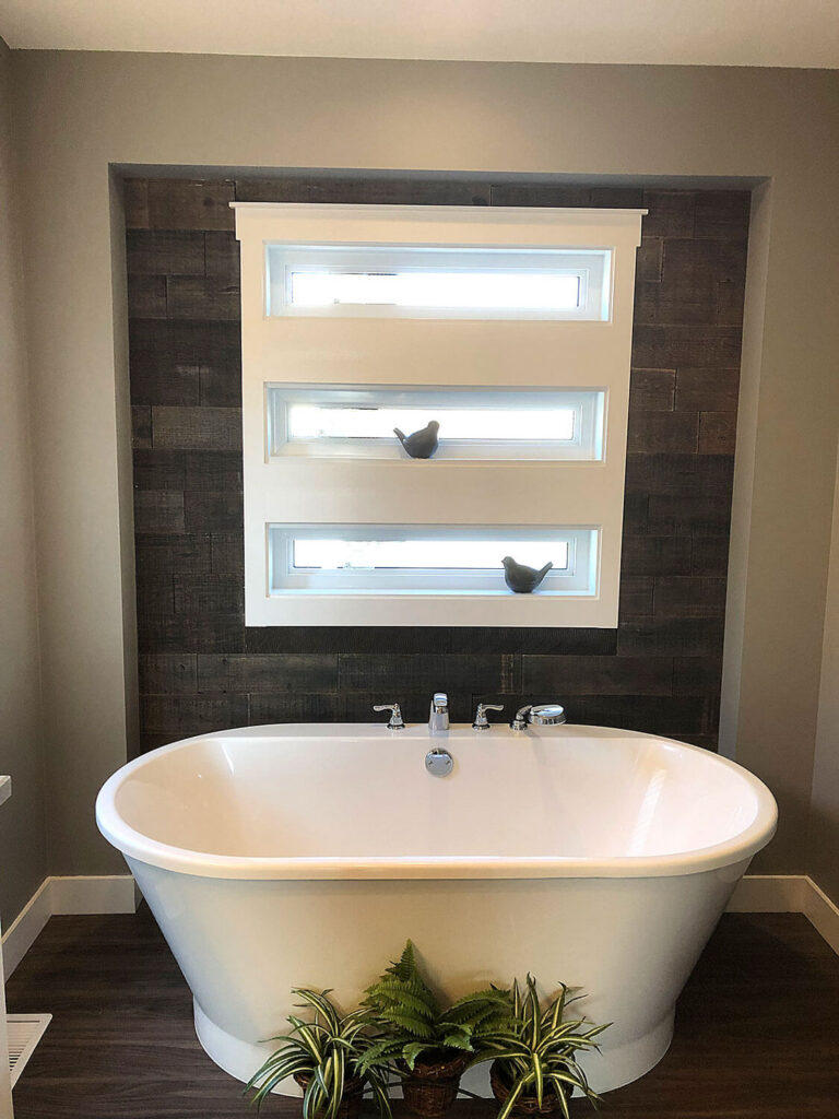 Freestanding soaker tub with barn board accent wall
