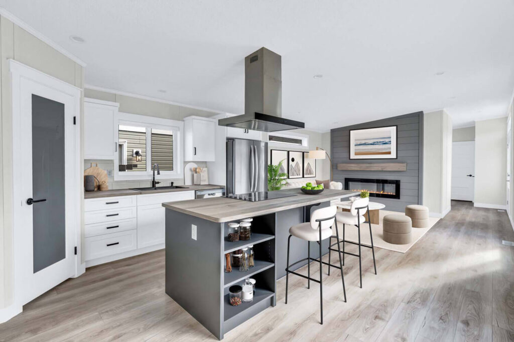 Modern kitchen with grey island, bar stools, white cabinets, and shiplap accent wall