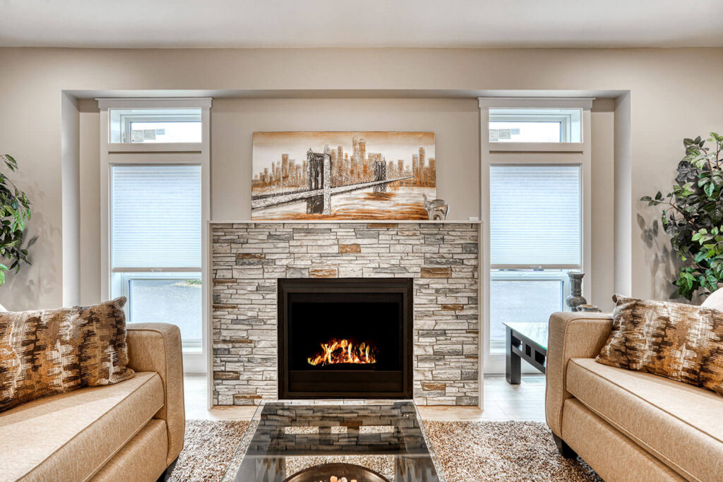 Stone fireplace living room with warm tones and two sofas