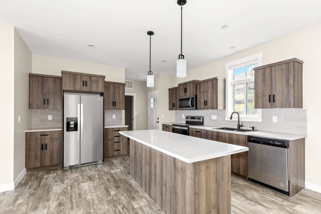 Rustic dark wood kitchen with large island, pendant lights, and subway tile